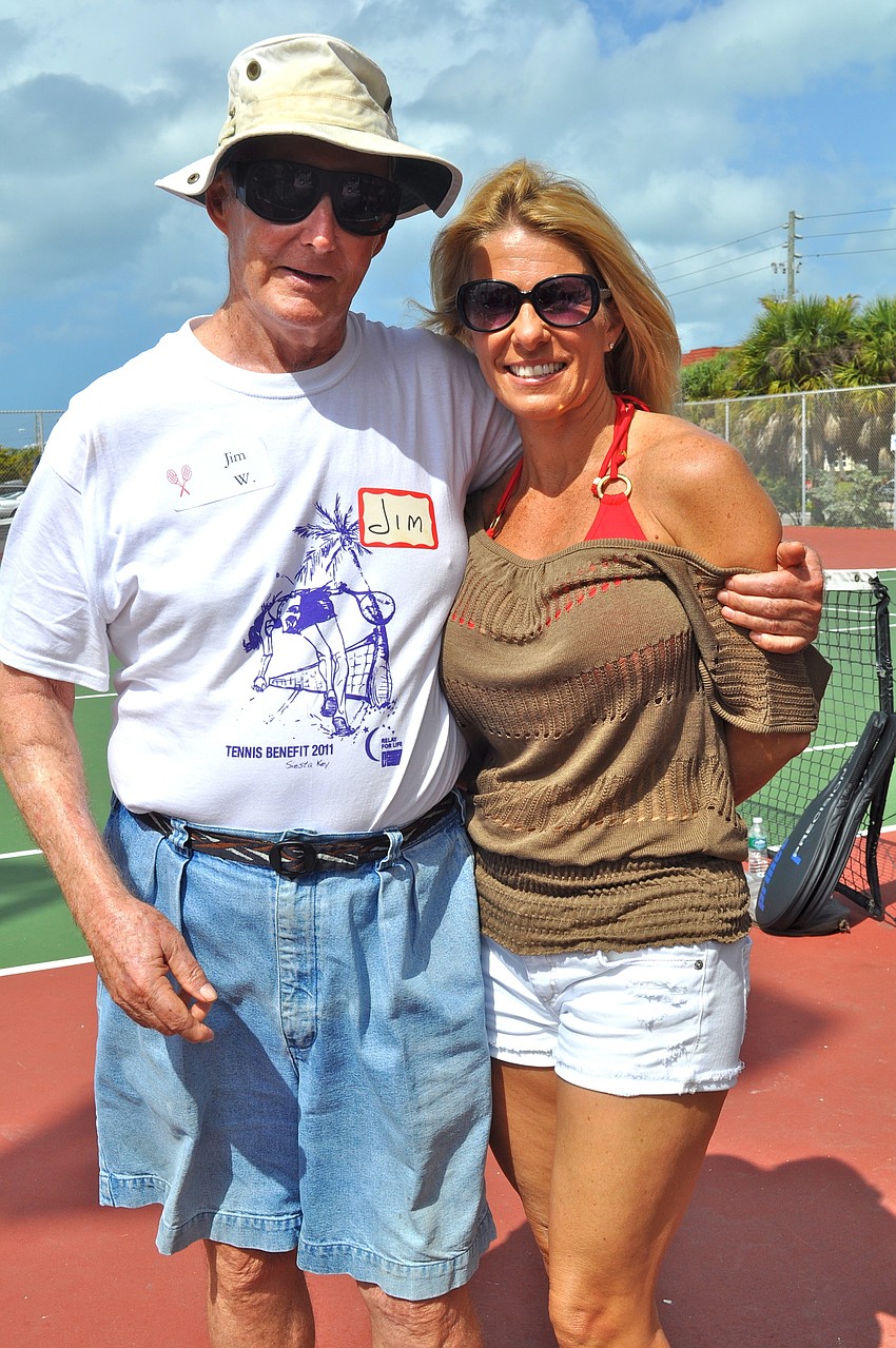 Sporting a Relay for Life T-shirt designed by Ringling College of Art and Design students, Jim Woods stands with and Kathy Schille.
