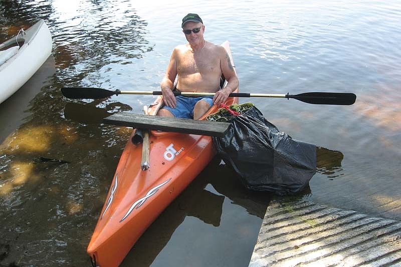 Volunteer Ron Piper collected trash by kayak.