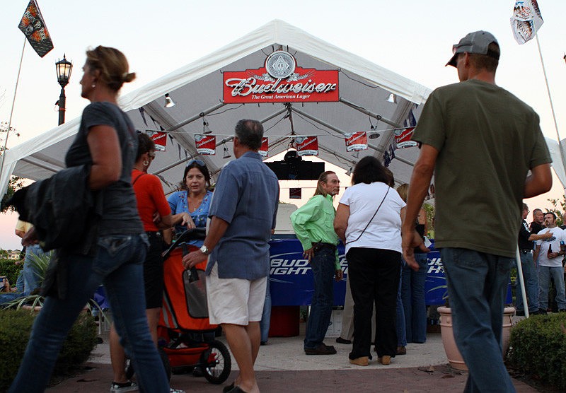 People enjoy their Budweiser beer, a sponsor for the event.