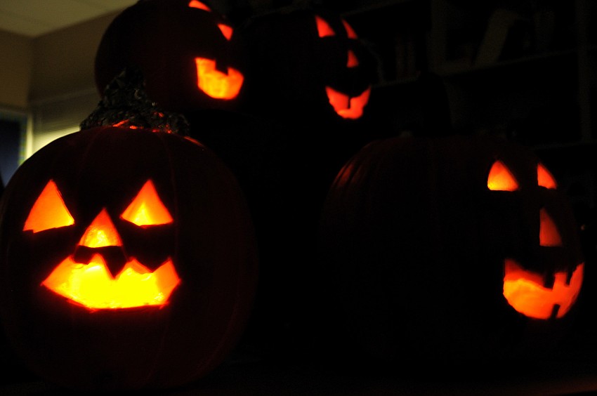 The students turned off the lights to admire their works of art.