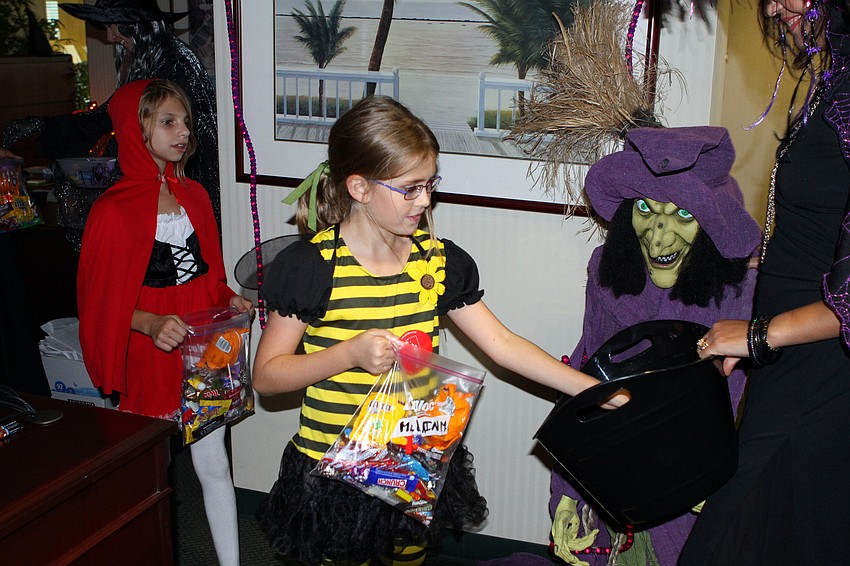 Audry Bradford and McLain Miller grab some more candy to add to their already heavy bags.
