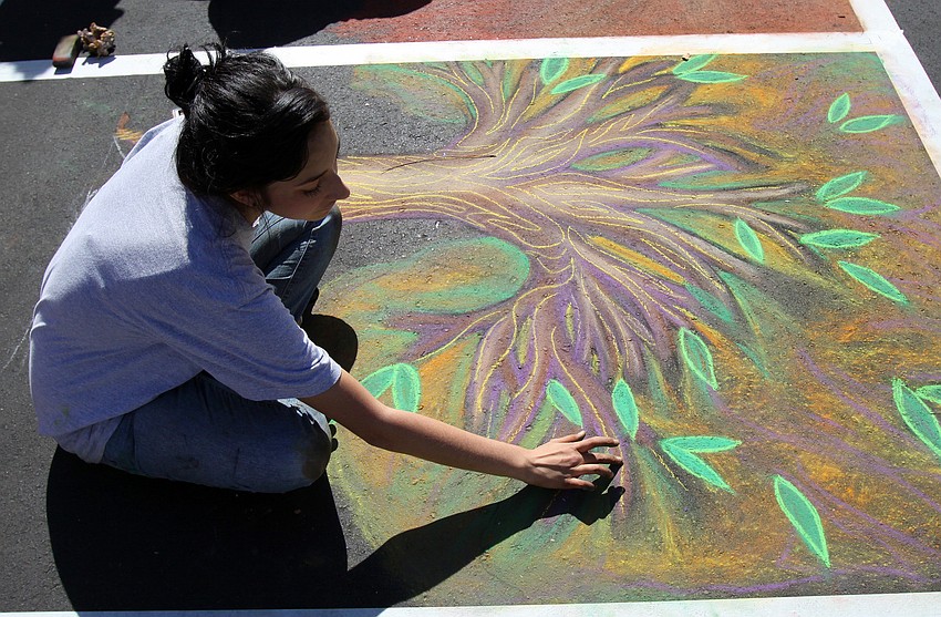 Briana Teresa Calderon works on her piece for the Chalk Festival