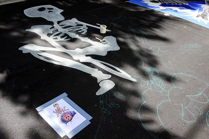 A lone chalk drawing not yet finished and the piece of paper that the artist is working from.