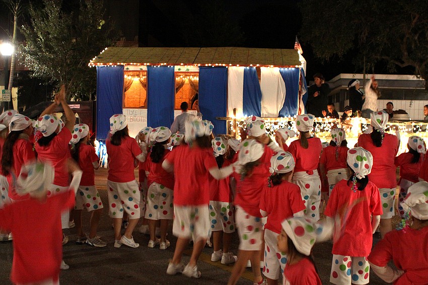Kids from Jump Dance Company wave as other floats start going down Main street for the parade.