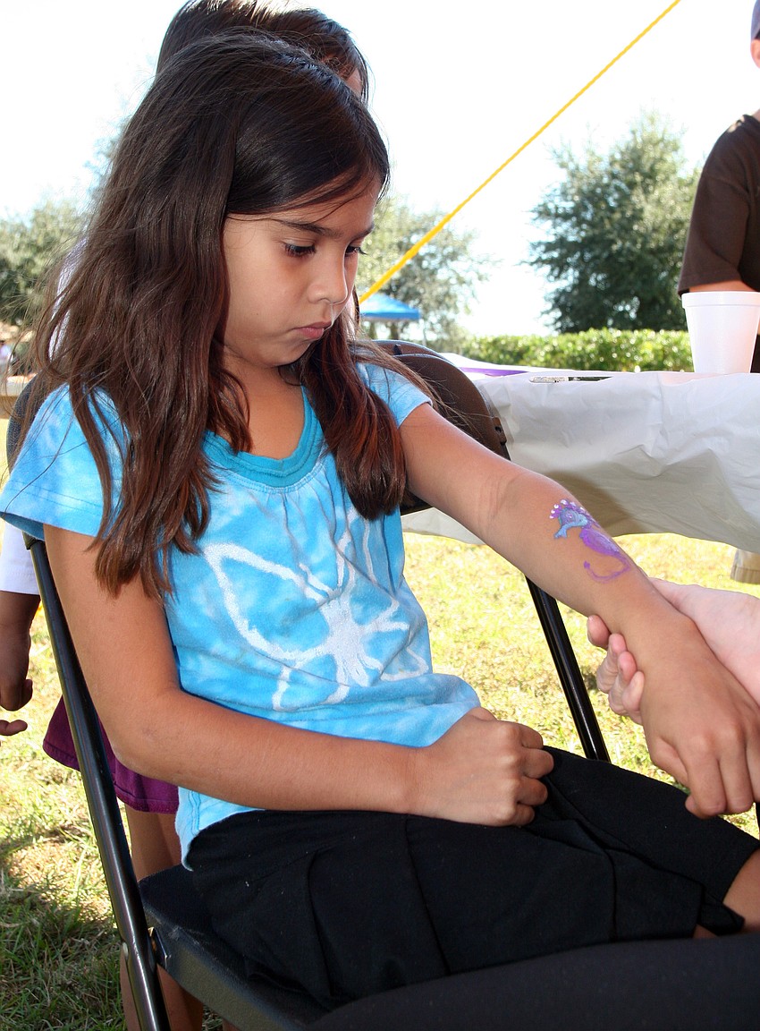 Eight-year-old Christina Aguero got a seahorse painted on her arm.