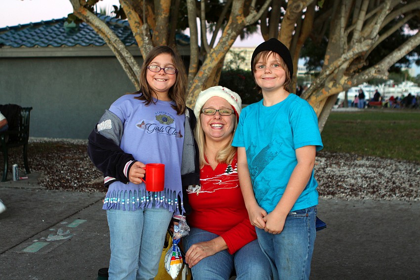 Nicole, Anne and Todd Weidler enjoy some festive family bonding as they wait for the boat parade to begin.