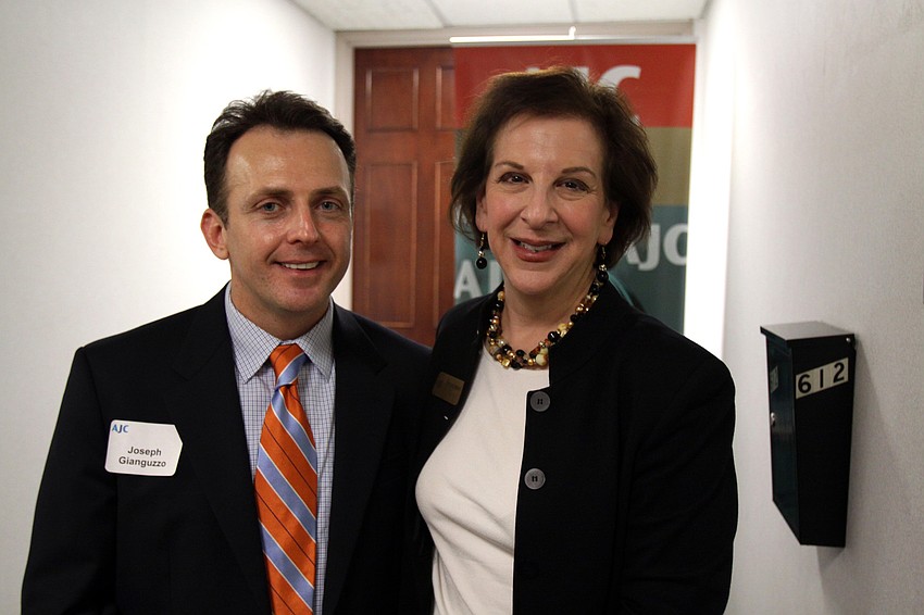 Joseph Gianguzzo and Sue Jacobson stand outside the new AJC office during AJCâ€™s Grand Opening Cocktail Party Thursday evening.