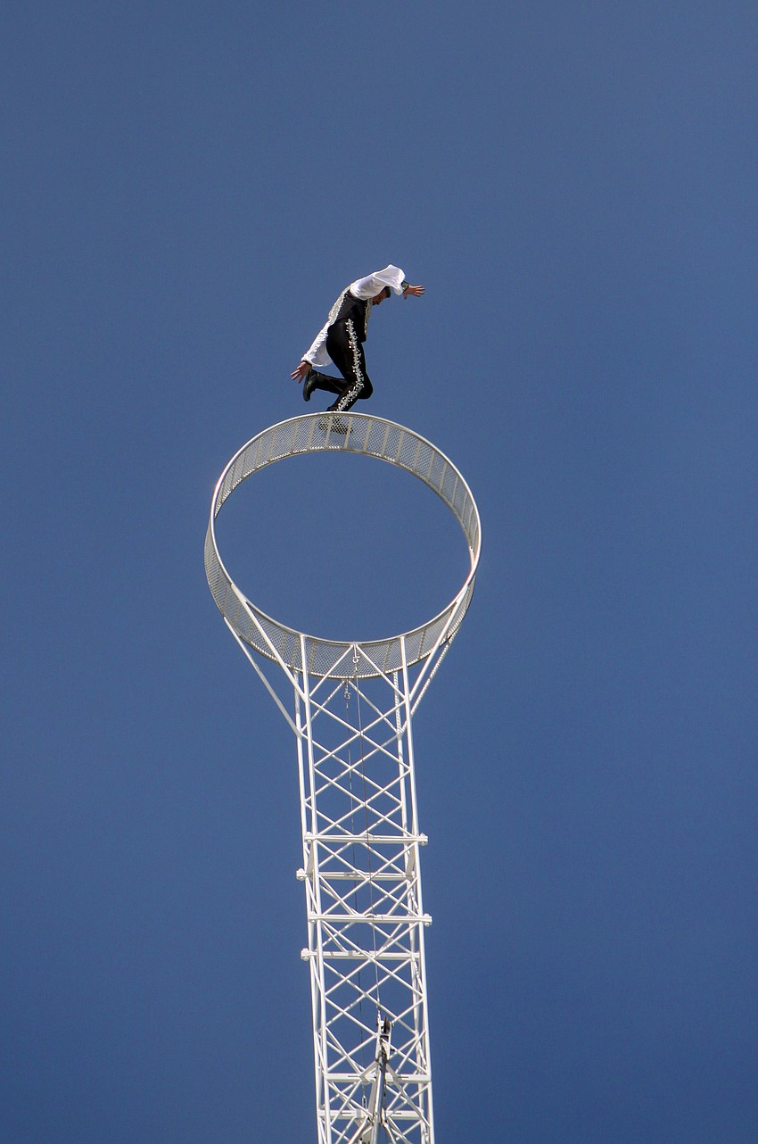 Joseph Bauer runs along the top of the â€œWheel of Destinyâ€ that was placed on top of the Watergate Condominium.