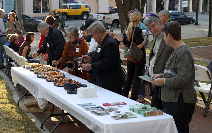 People attending the Intersections Kickoff Celebration enjoy the food that was catered by Paul Caragiulo.