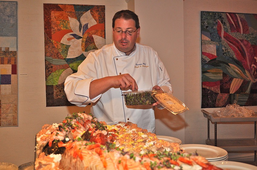 Chef Joe Santangini puts the final touches on his seafood buffet.