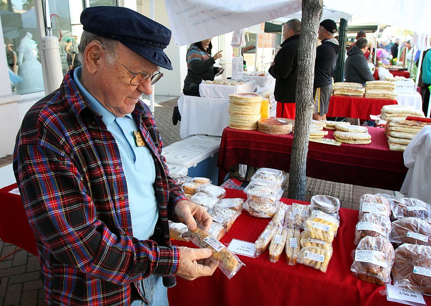John Cream, part owner of Sweet Bread by Grandma, shows off some of the biscotti they make and sell at the farmers market.