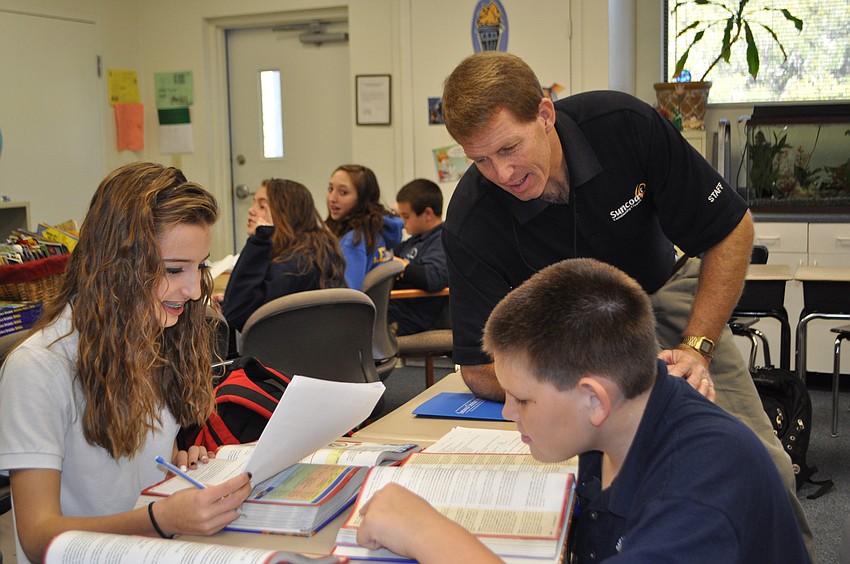 Eighth-graders Jilissa Zoltko and J. Paul Lacey study the U.S. Constitution with Suncoast Church Pastor, Joe Bradshaw