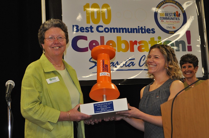 Debbie Lister, Senior Vice President of Partner Engagement at America's Promise Alliance, presents Karen Bogues, director of Community Youth Development of Sarasota County, with the award.