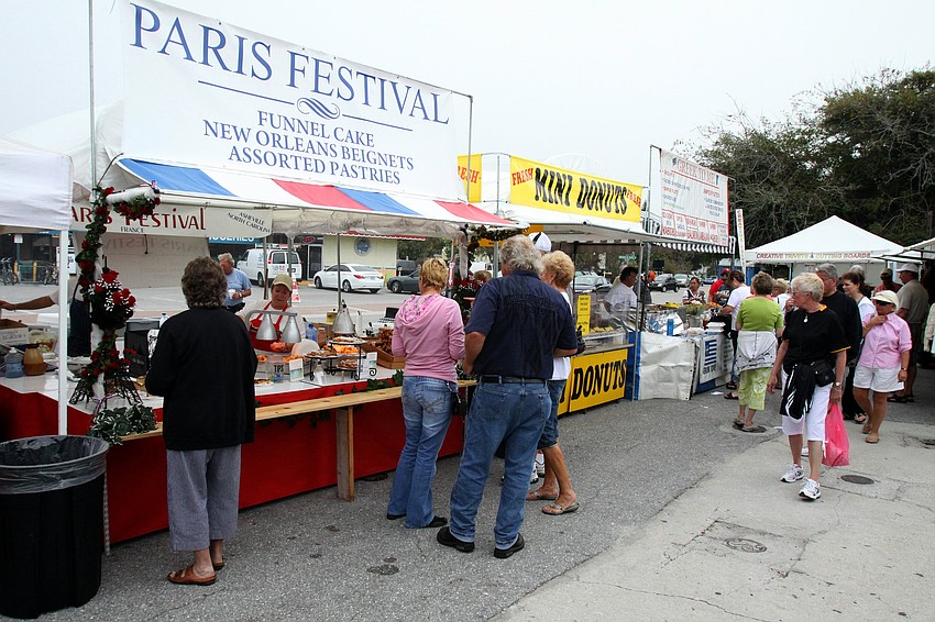 People attending the 17th annual Siesta Key Craft Festival make their way over to the food area for funnel cakes, hot dogs and kettle corn Saturday, Feb. 5, in Siesta Key Village.
