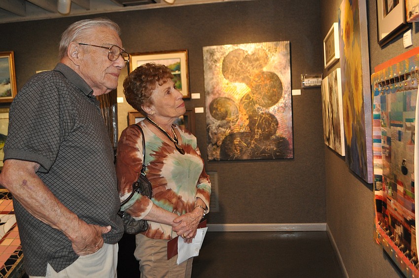 Howard and Libby Garnitz admire artwork.