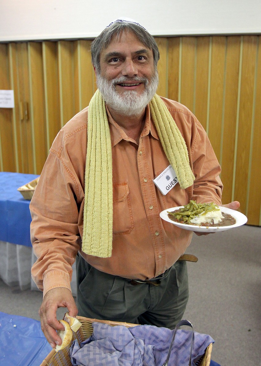 Marvin Gutar gets some bread during Shabbat Alive! dinner on Friday, Feb. 11 at Temple Emanu-El.