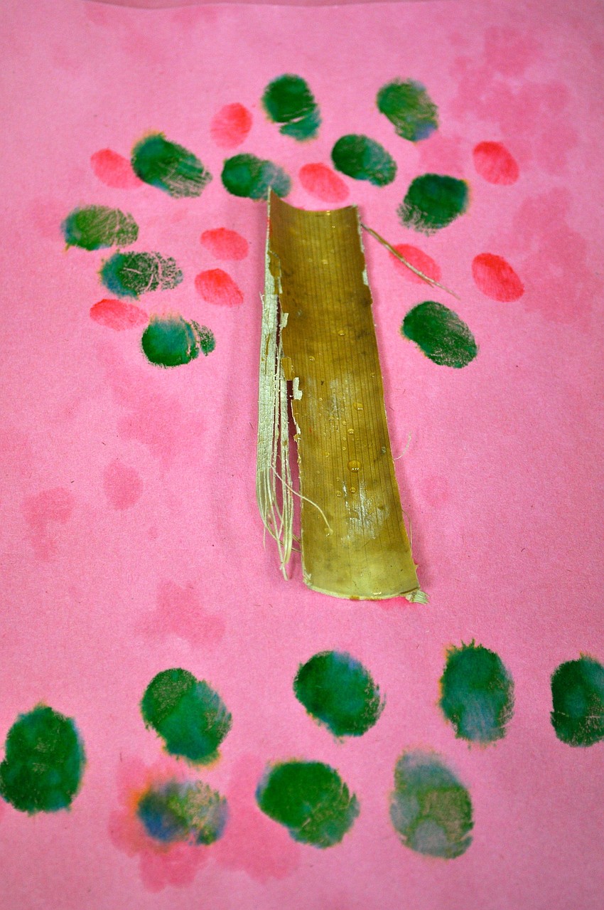 Several children painted Johnny Appleseed trees.