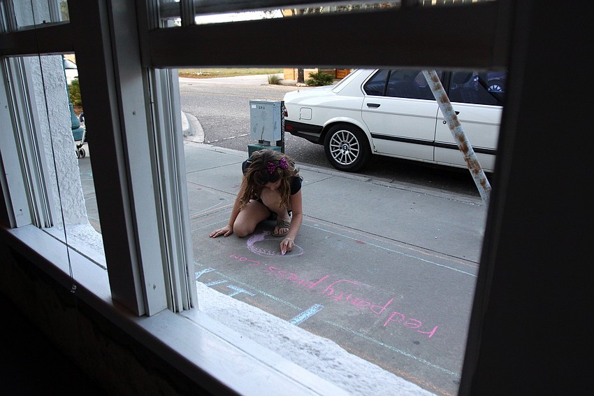 Raven Gamber, 12, enjoys drawing with chalk on Thursday, March 3 during Rosemary Rising.