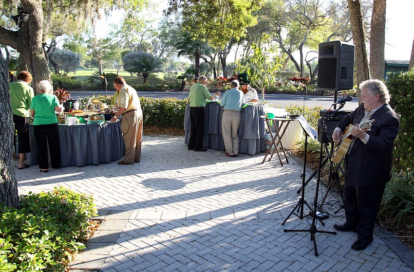Gary Lesher sings some Irish tunes while people get some appetizers and drinks on Thursday, March 17 at Longboat Key Club's outdoor Harbourside dining patio.