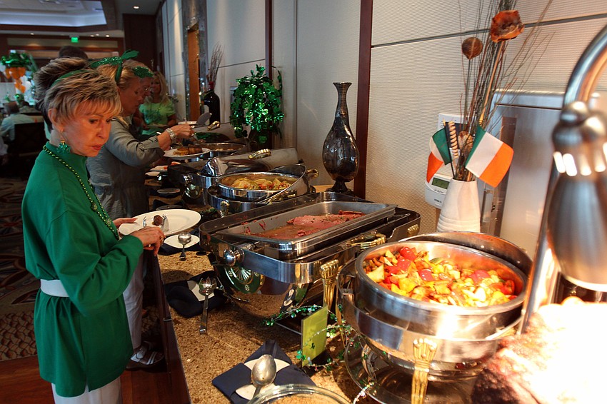 Joy Server looks at the buffet table at Sarasota Yacht Club's St. Patrick's Day dinner.