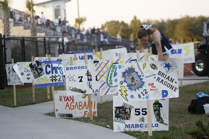 Homemade signs lined the path from the school grounds to Thunder Stadium.