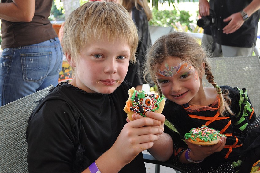 Jack O'Hara, age 10, and his 5-year-old sister Ava enjoy some Halloween treats.