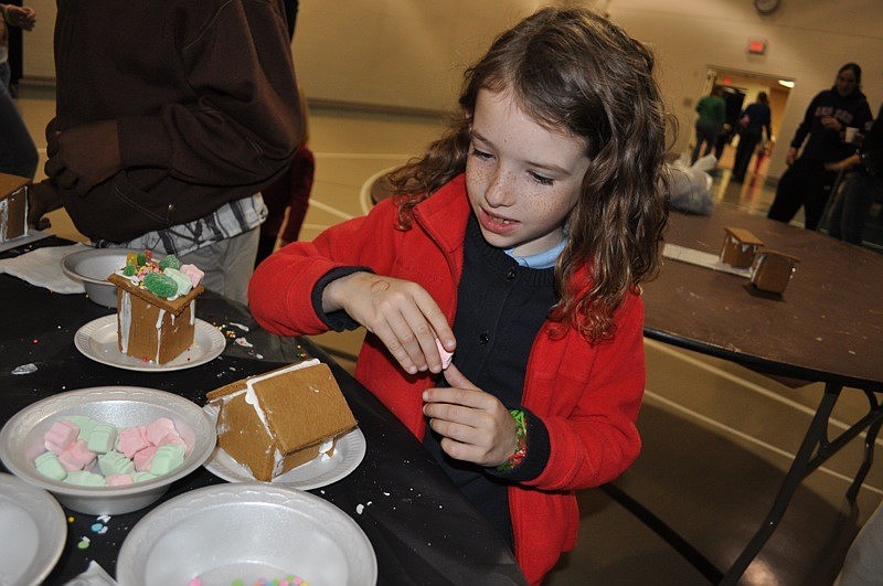 Six-year-old Lindsay Soss eagerly decorated her gingerbread house.