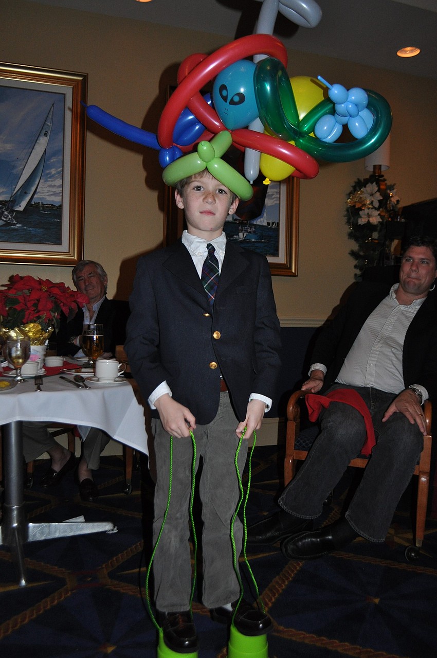Henry Castilow got a giant balloon hat and a pair of moon boots from Santa.