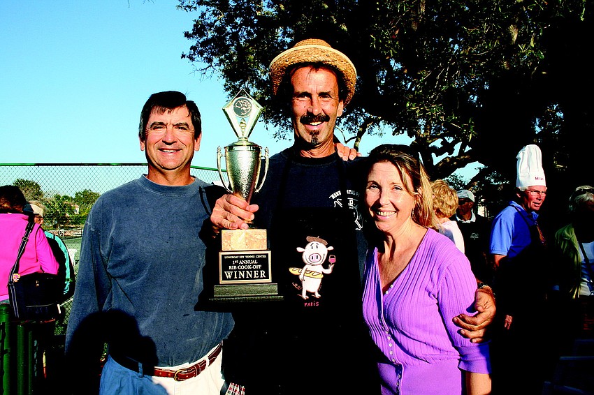 Dave Sparks, left, and Grace Hackett, right, pose with Longboat Key Public Tennis Center Ribfest cook-off winner Tim Fitzpatrick in February.