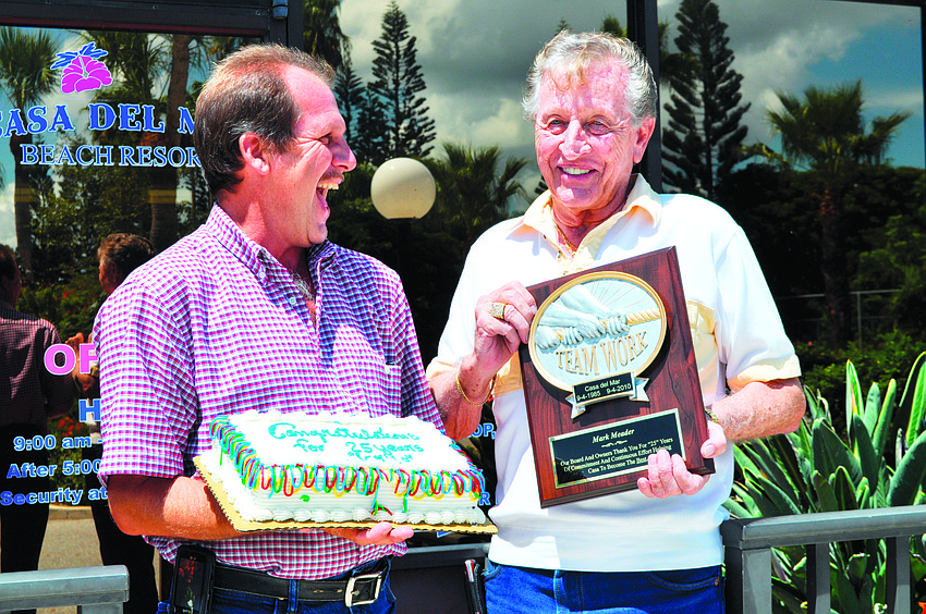 In September, Casa del Mar General Manager D.M. Williams, right, presents Casa del Mar Assistant General Manager Mark Meador with a plaque commemorating his 25 years at the resort.