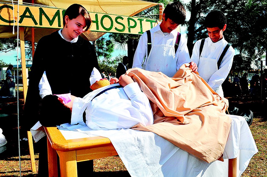 Anthony Guarnieri (lying down), Monica Morgan, Cole Dabney and Nicholas Danese taught students about the lack of medicine and infectious diseases in March at Sarasota Middle School's Civil War Camp Day.