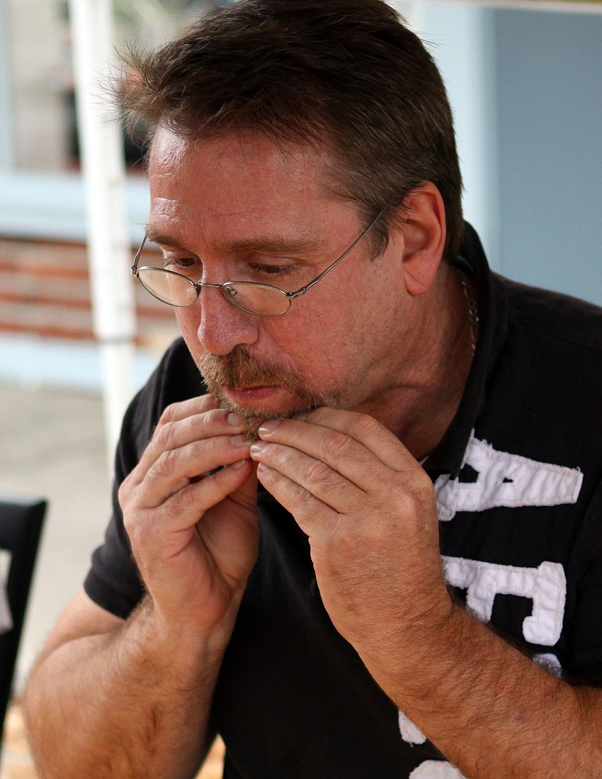 Dr. Patrick Dower tries to make his mouth chew faster in order to win Veg's First Annual Veggie Burger Eating Contest on Saturday, Feb. 5 outside of Veg.