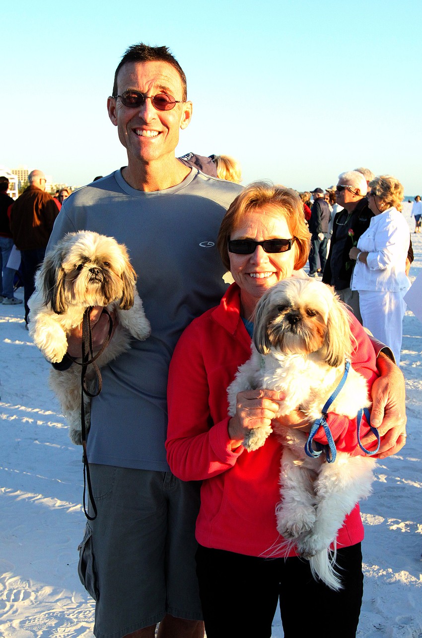 Jeff and Maureen Stewart attend the Say I Do, Again ceremony with their dogs Talia and Tobias, Monday, Feb. 14 on Siesta Key Beach.