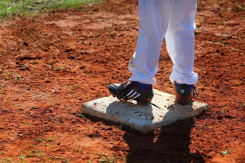 Will Hilton, 6, stands on first base after making it there safely during his game on Saturday, Feb. 19 at Twin Lakes Park during Central Sarasota Little League Opening Day.