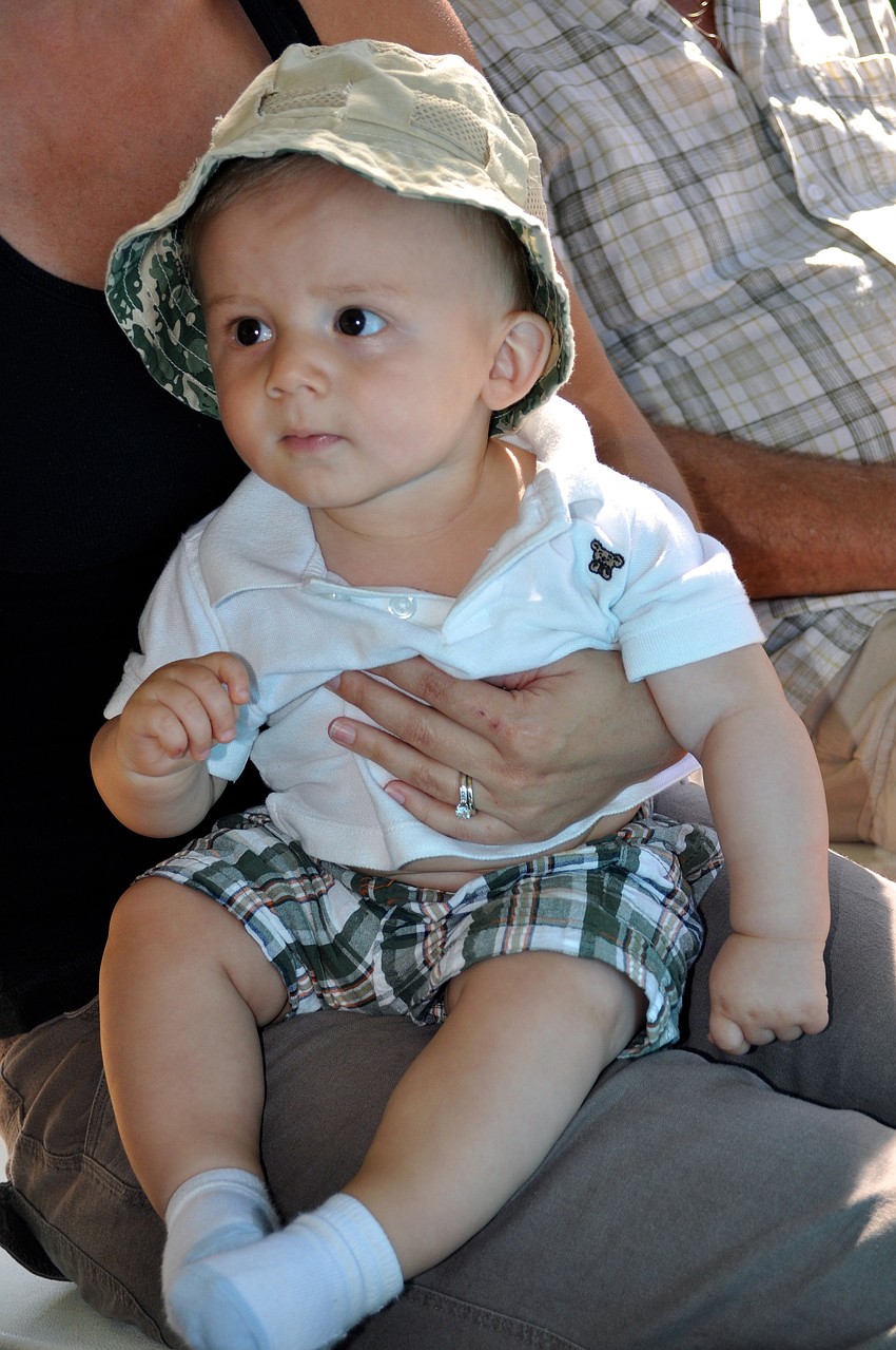 Adam Krefft sits on his mom's lap as the band starts up.