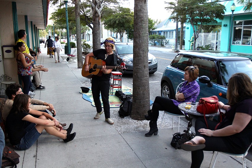 Kenra plays the guitar outside of Everything but the Girl and The Closet during Rosemary Rising.