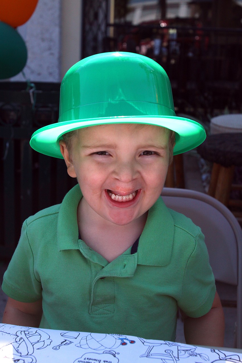 Henry Lehnert, 4, smiles big in a green bowler hat on on Thursday, March 17 at Lynches Pub.