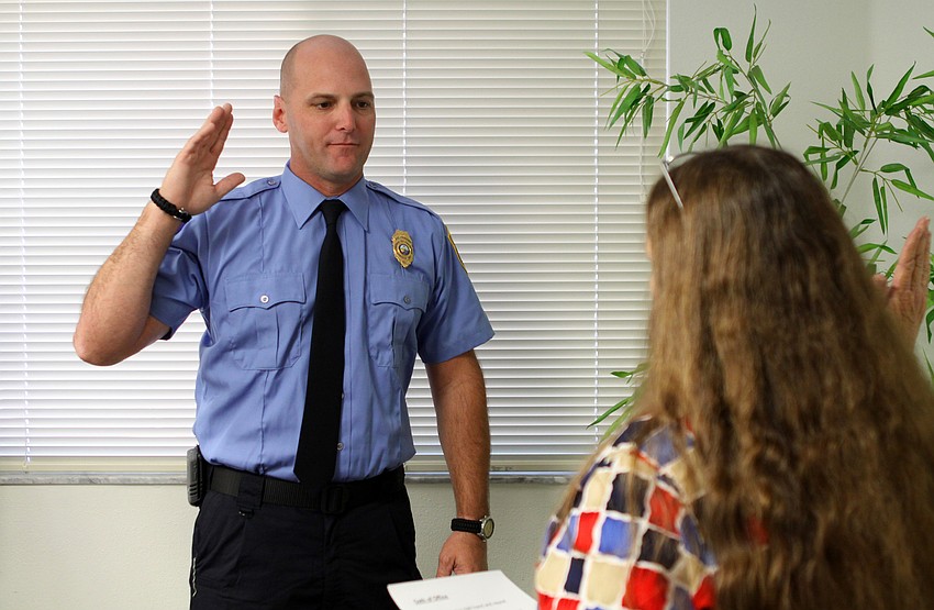 Tim Haas swears in as the new lieutenant by town clerk, Trish Granger.
