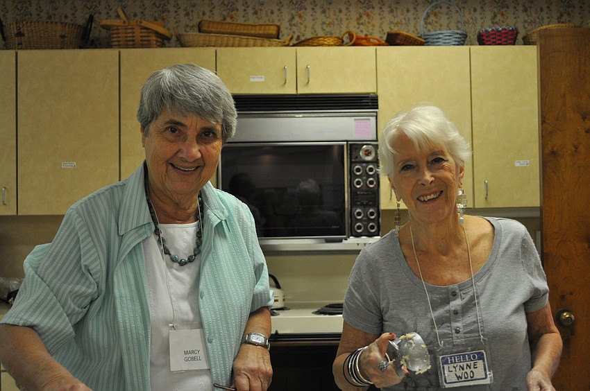 Marcy Gobell and Lynne Woo serve lunch.