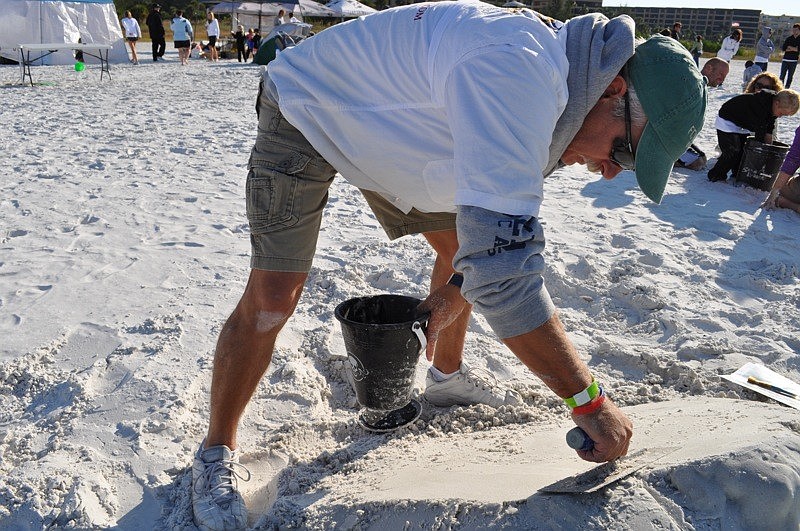Bill Knight did a sand sculpture of the Center for Autism Research and Education's logo.