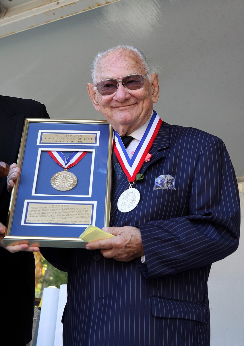 Ward Hall shows off his award to the crowd on Sunday. Hall said that his induction into the Ring of Fame is â€œthe most wonderful honor [he] could possibly imagineâ€.