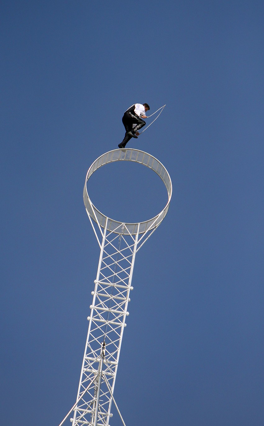 Joseph Bauer jumps rope while riding the â€œWheel of Destinyâ€. The wheel was placed on top of the Watergate Condominium, a 19-story building.