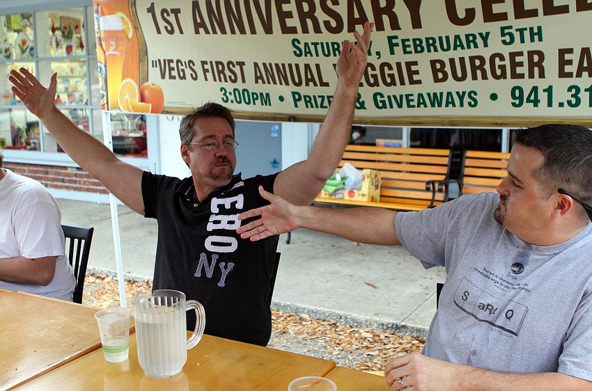 Dr. Patrick Dower raises his arms in victory as 2nd place winner, Chris DeLeonardo goes to shake Dower's hand during Veg's First Annual Veggie Burger Eating Contest on Saturday, Feb. 5 outside of Veg.