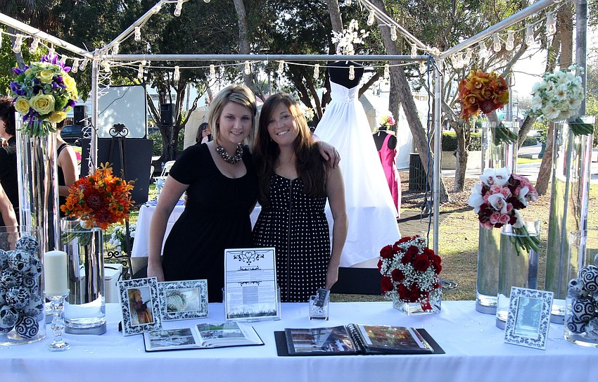 Whitney Prewitt and Michelle Bilodeau of The Naked Florist pose together behind their booth on Saturday, Feb. 266 at St. Armands Circle's Weddings in Paradise Circle of Love event.