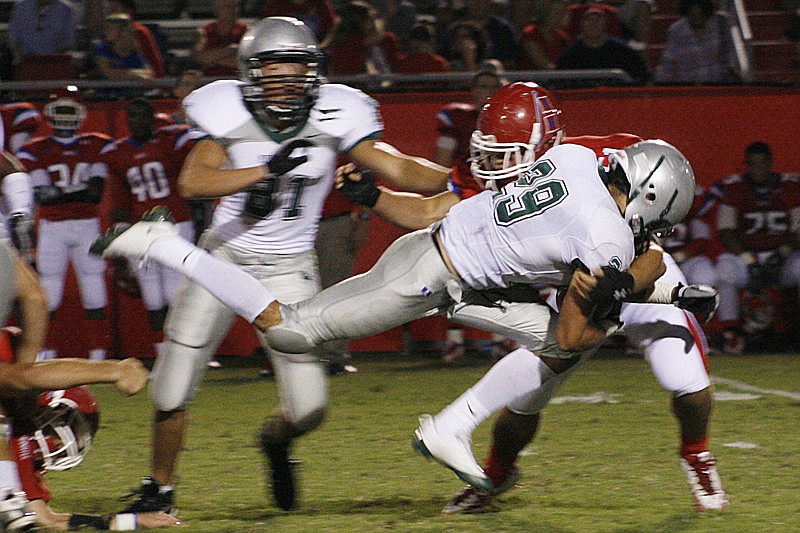 Harrison Skokos goes airborne to gain a few extra yards for the Mustangs.