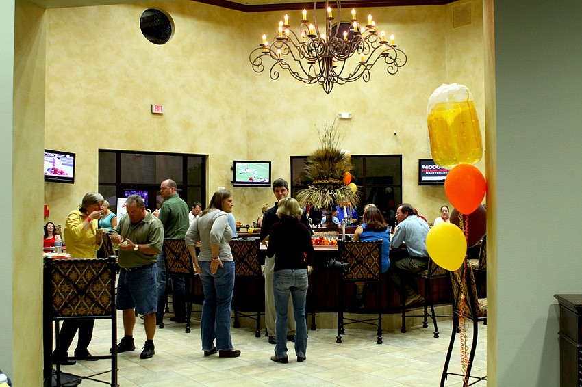 People enjoying some food and beer at Oktoberfest.