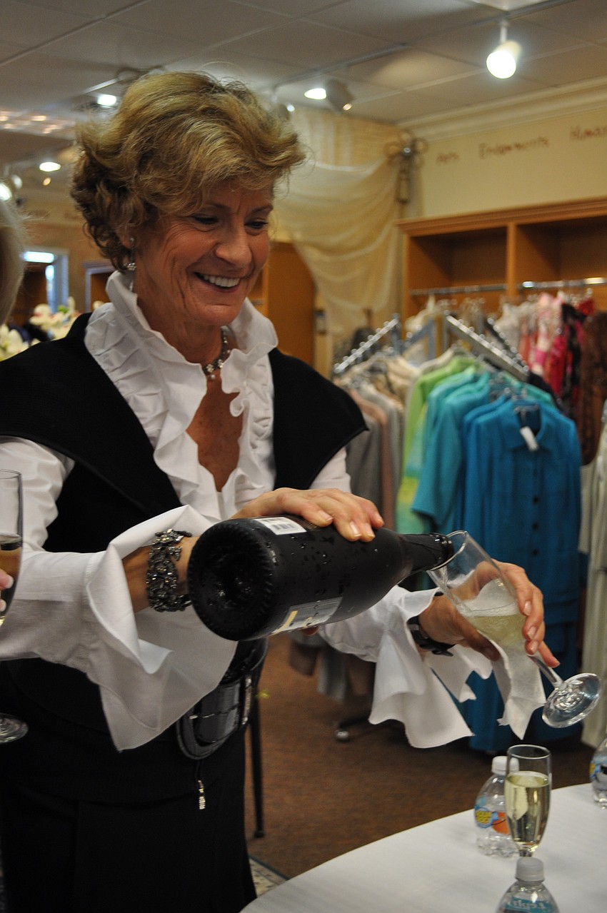 Galen Bacon pours champagne for guests.