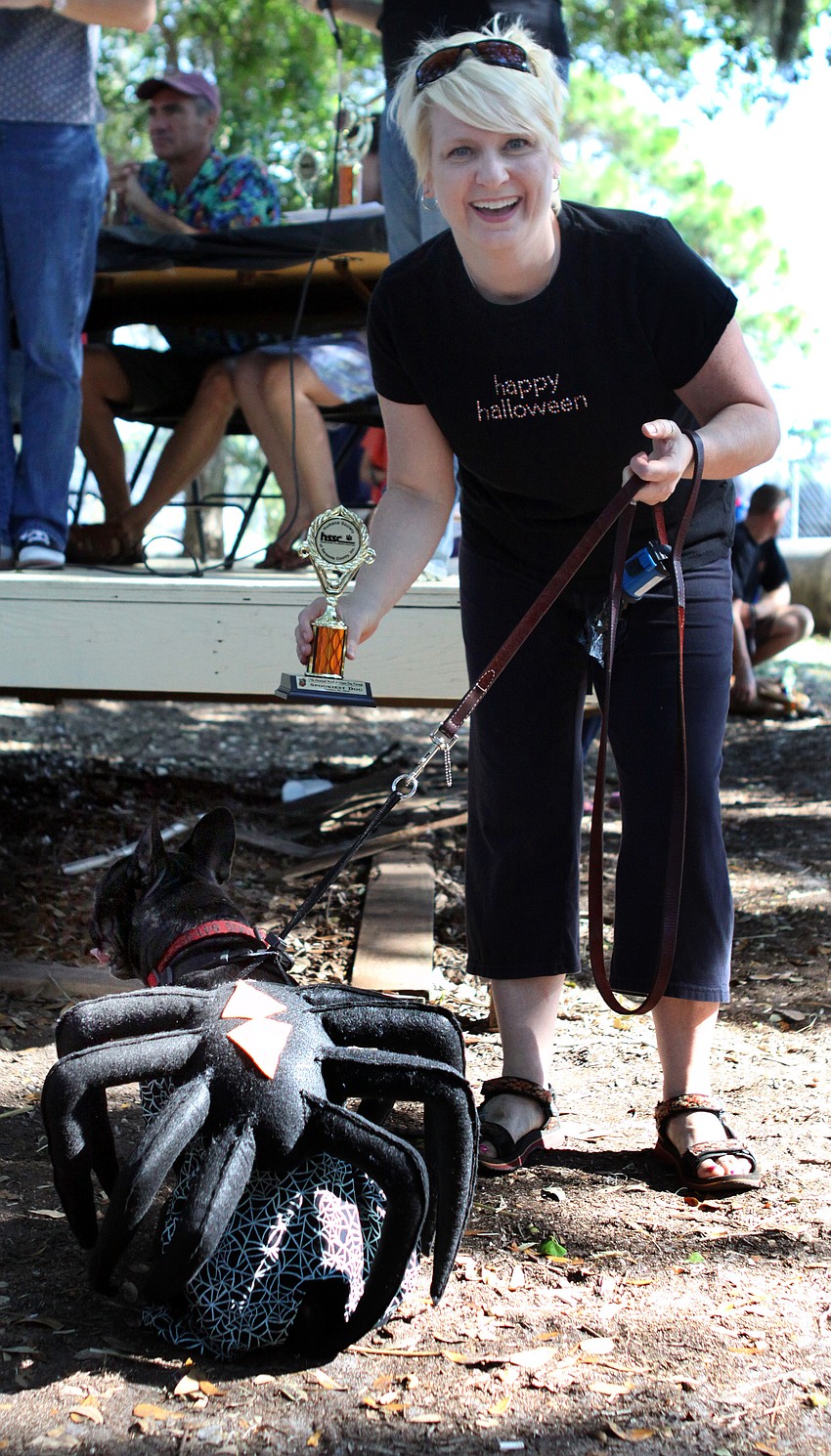 Seamus models his spider outfit while Michelle Blankenship shows off their trophy.