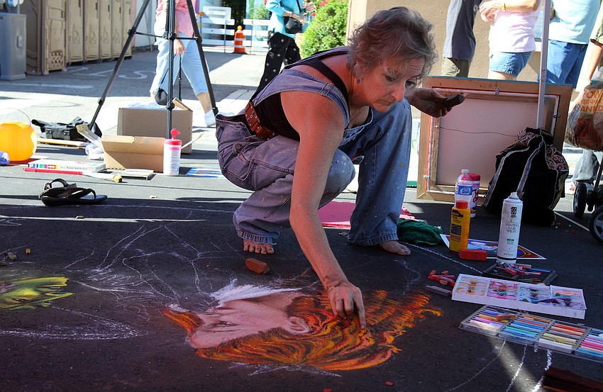 Dorothy Sabean-Davis works on a piece featuring Dorothy and the Wicked Witch of the West.
