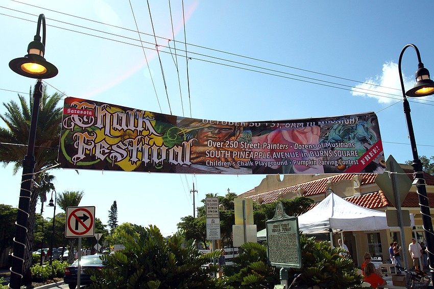 A sign hangs in Burns Court advertising the Chalk Festival.
